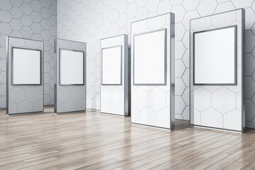 Modern gallery interior with wooden flooring, empty white mock up posters on concrete wall. Museum concept. 3D Rendering.