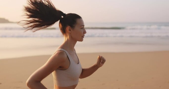 Female Runner Jogging During Outdoor Workout on the Beach in Slow
