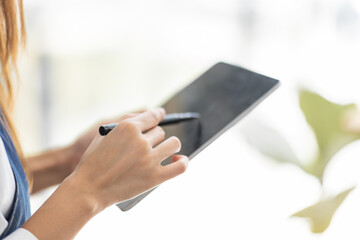 Startup successful small business owner sme beauty girl stand with tablet smartphone in coffee shop restaurant. Portrait of asian tan woman barista cafe owner. SME entrepreneur seller business concept