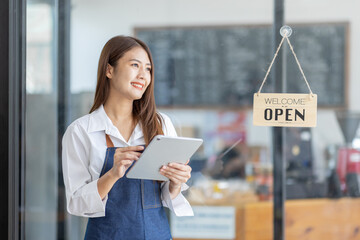 Startup successful small business owner sme beauty girl stand with tablet smartphone in coffee shop...