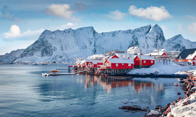 Red wooden houses on the shore of Norwegian sea. Picturesque winter view of Hamnoy village, Lofoten Islands. Frosty morning scene of Norway, Europe. Traveling concept background.. © Andrew Mayovskyy