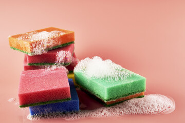 Obraz na płótnie Canvas soap foam and sponges on a pink background