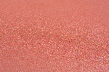Texture of red sandpaper. Rough sandpaper background. Copy Space for designers to use on sandpaper.