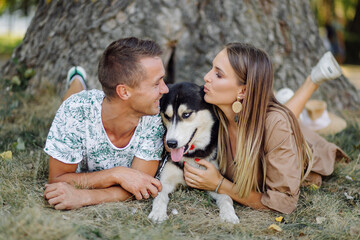 Young couple and husky