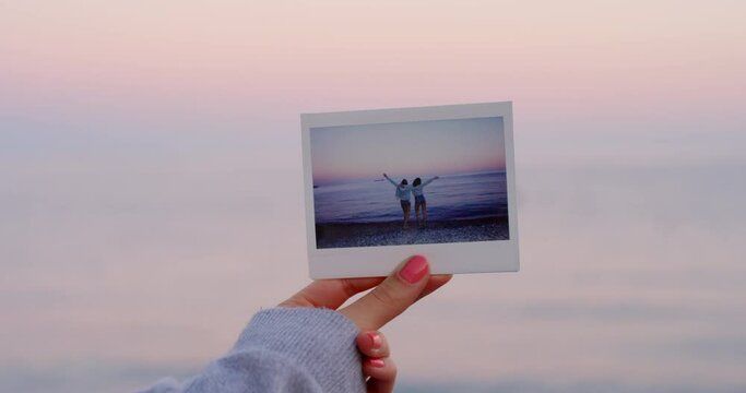 Women, polaroid or beach picture at sunset in travel location, Italy summer break or tropical holiday vacation. Happy, freedom or bonding friends with photograph by sunrise nature, ocean or sea waves