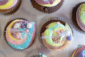 Paper toy ballet fairy decoration on many colourful muffin cakes