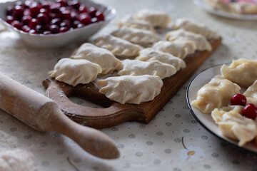 Homemade raw dumplings with cherries. Cooking at home.