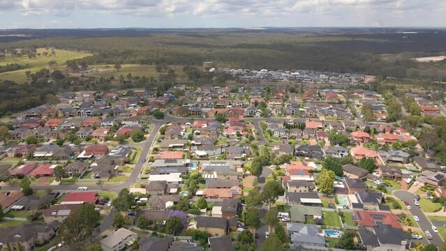 Aerial drone view of Voyager Point in South West Sydney, NSW Australia heading toward the train line and Heathcote Road  