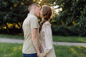 Fototapeta premium Young couple in love outdoor.Stunning sensual outdoor portrait of young stylish fashion couple posing in summer in field