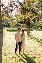 Fototapeta premium Young couple in love outdoor.Stunning sensual outdoor portrait of young stylish fashion couple posing in summer in field