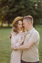 Young couple in love outdoor.Stunning sensual outdoor portrait of young stylish fashion couple posing in summer in field