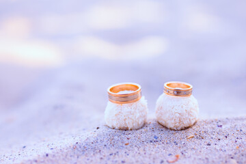 Wedding rings with candies on a sand. Wedding concept 
