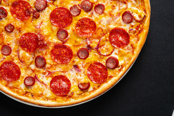 salami pizza on the black background