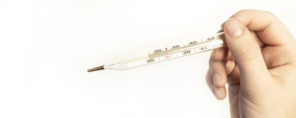 Medical glass old mercury thermometer in hand on a white background. Thermometer. Medicine,...