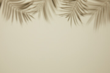 blurry and abstract of silhouette palm leaves shadow on beige wall. copy space and flat lay