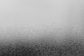 Dew drops and condensation on glass, cold season and high humidity on windows in houses.