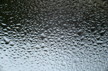large dew drops on the window after condensation has settled on the window.