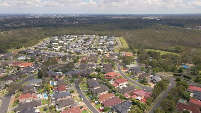 Aerial drone view of Voyager Point in South West Sydney, NSW Australia showing development of housing and parks with Liverpool CBD in the distant background   