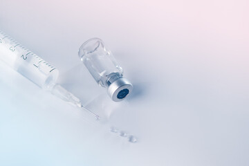 Glass vial and syringe with injection. Vaccination or beauty therapy concept.