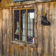 Close up wooden cabin window concept photo. Traditional home in forest. Front view photography with...