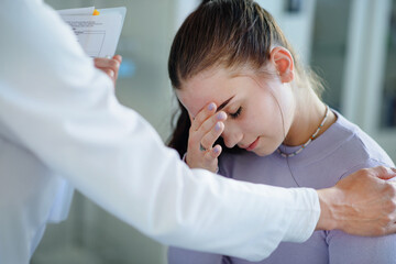 Close-up of doctor consoling unhappy teenage girl in her ambulance office.