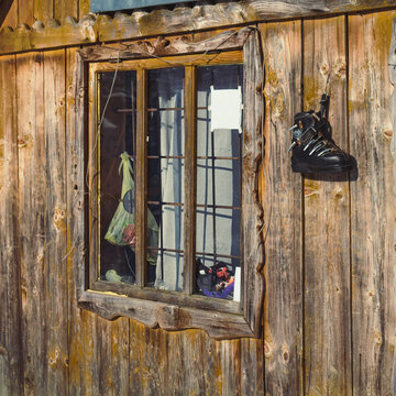 Close up wooden cabin window concept photo. Traditional home in forest. Front view photography with house exterior on background. High quality picture for wallpaper, travel blog, magazine, article