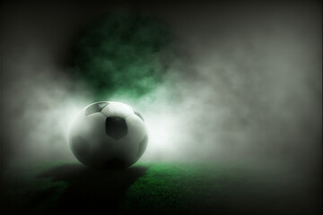 Ball on gras in soccer stadium with illumination at night