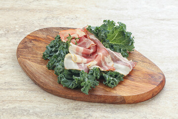 Raw pork bacon over board