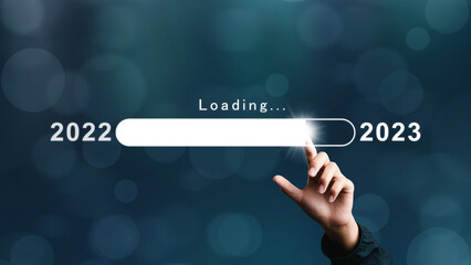 Businessman pointing bar numbers loading virtual new year 2023 to countdown from 2022 merry christmas arrangements. goal plan. goal concept. action plan, strategy, new year business vision