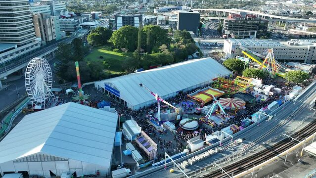 Drone aerial shot of Brisbane Showgrounds during the Ekka carnival celebration, very busy crowd attending the rides and attractions, Brisbane QLD