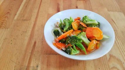A bowl of cap cay vegetables on wooden table