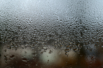 Dew drops and condensation on glass, cold season and high humidity on windows in houses.