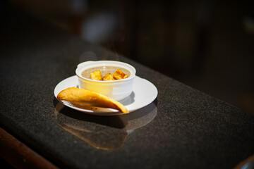 Splendid Shiitake mushroom soup and garlic toast on the black table stock photo
