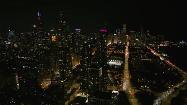 Aerial view around a luxury apartment complex, in Near South Side, nighttime in Chicago, USA - orbit, drone shot