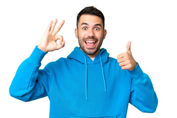 Fototapeta premium Young handsome caucasian man over isolated chroma key background showing ok sign and thumb up gesture