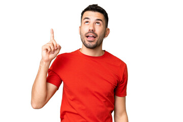 Fototapeta premium Young handsome caucasian man over isolated chroma key background pointing up and surprised