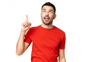 Young handsome caucasian man over isolated chroma key background pointing up and surprised