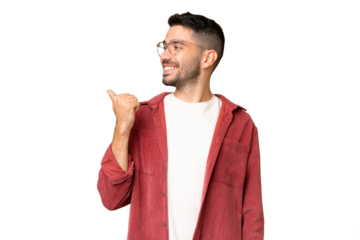 Young handsome caucasian man over isolated chroma key background pointing to the side to present a product