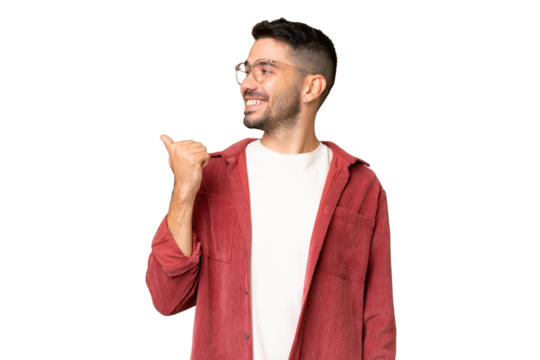 Young handsome caucasian man over isolated chroma key background pointing to the side to present a product