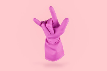 Pink cleaning glove doing the metal rock geture with his fingers on a pink background