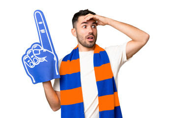Young caucasian sports fan man over isolated chroma key background doing surprise gesture while looking to the side