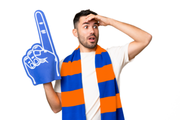 Young caucasian sports fan man over isolated chroma key background doing surprise gesture while looking to the side