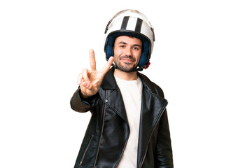 Young caucasian man with a motorcycle helmet over isolated chroma key background smiling and showing victory sign