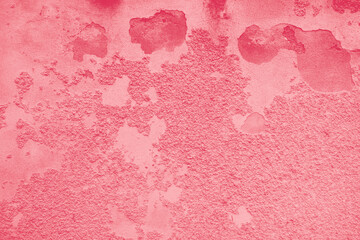 Background of peeling Magenta paint on an old wall. Texture background of an old wall made of plaster. Cracks. Copy space. Old peeling plaster wall, crumbles. Color Of The Year 2023 - Viva Magenta.