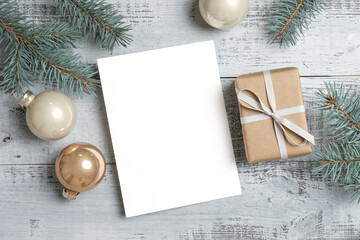 Geeting card mockup with christmas gift box and fir tree branches