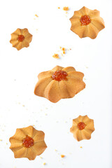 Levitating sweet butter cookies on white background.
