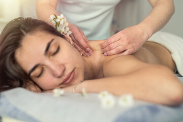 close up of female hands make  therapeutic massage for woman client relaxing on table in spa salon