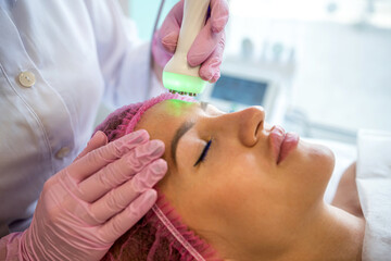 young cosmetologist cleans his face in a cosmetology office.