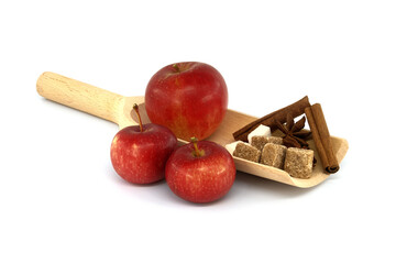 Cinnamon sticks, sugar and anise stars placed in wooden scoop