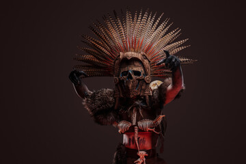 Shot of creepy zombie woman dressed in dark aboriginal attire and ceremonial headdress.